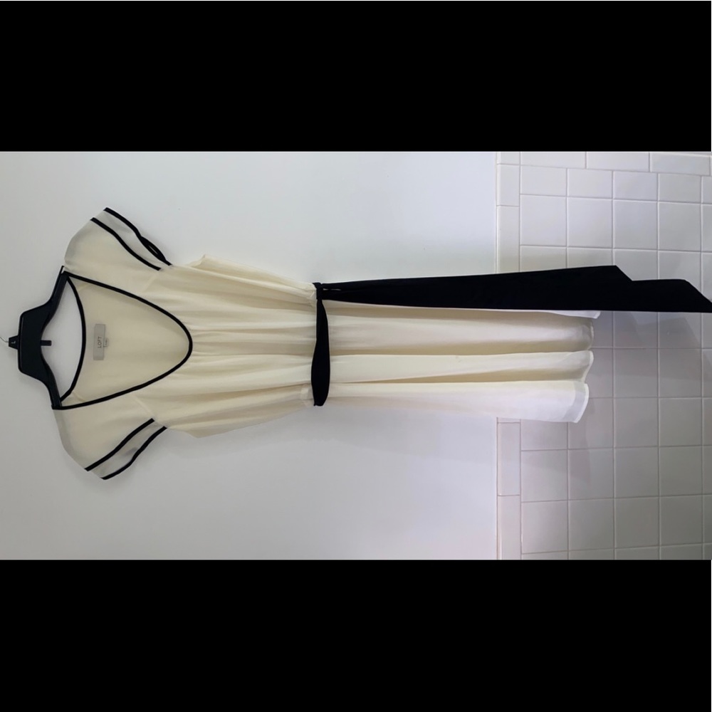 Very pretty ivory dress with black triim and belt.